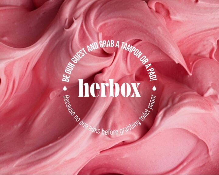 Rosa glass med texten "Herbox" och uppmaningar om att ta en tampong eller bindor fritt.